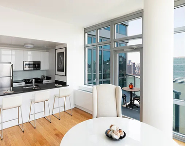 4545 Center BoulevardStunning 1 bed apartment featuring a home office area and private balcony with partial views of the East River. This home also features a spacious living area, open kitchen, ample closet space, and southern exposure. - Photo Thumbnail 3