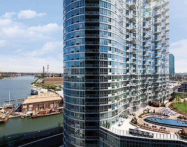 4545 Center BoulevardStunning 1 bed apartment featuring a home office area and private balcony with partial views of the East River. This home also features a spacious living area, open kitchen, ample closet space, and southern exposure. - Photo Thumbnail 7