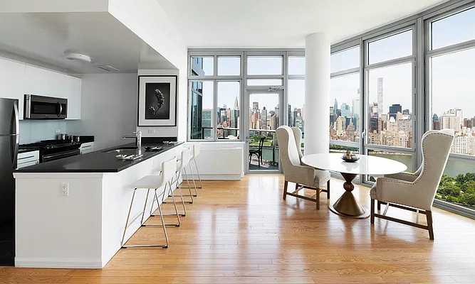 4545 Center BoulevardStunning 1 bed apartment featuring a home office area and private balcony with partial views of the East River. This home also features a spacious living area, open kitchen, ample closet space, and southern exposure. - Photo 2