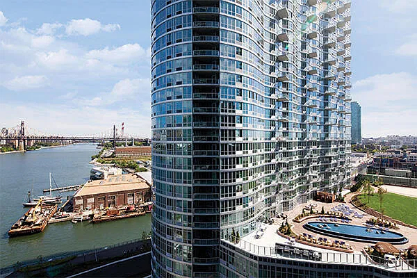 4545 Center BoulevardStunning 1 bed apartment featuring a home office area and private balcony with partial views of the East River. This home also features a spacious living area, open kitchen, ample closet space, and southern exposure. - Photo 7
